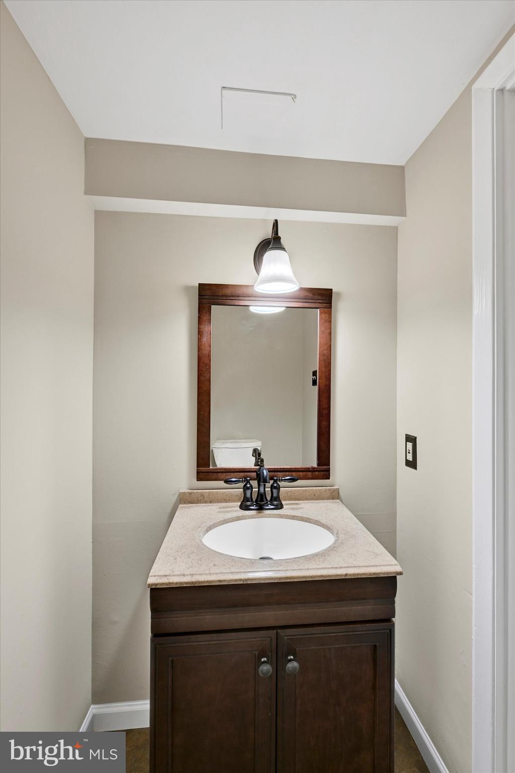 3447 Santee Road Baltimore, MD 21236 - Photo 27 of 32 a bathroom with a sink and a mirror