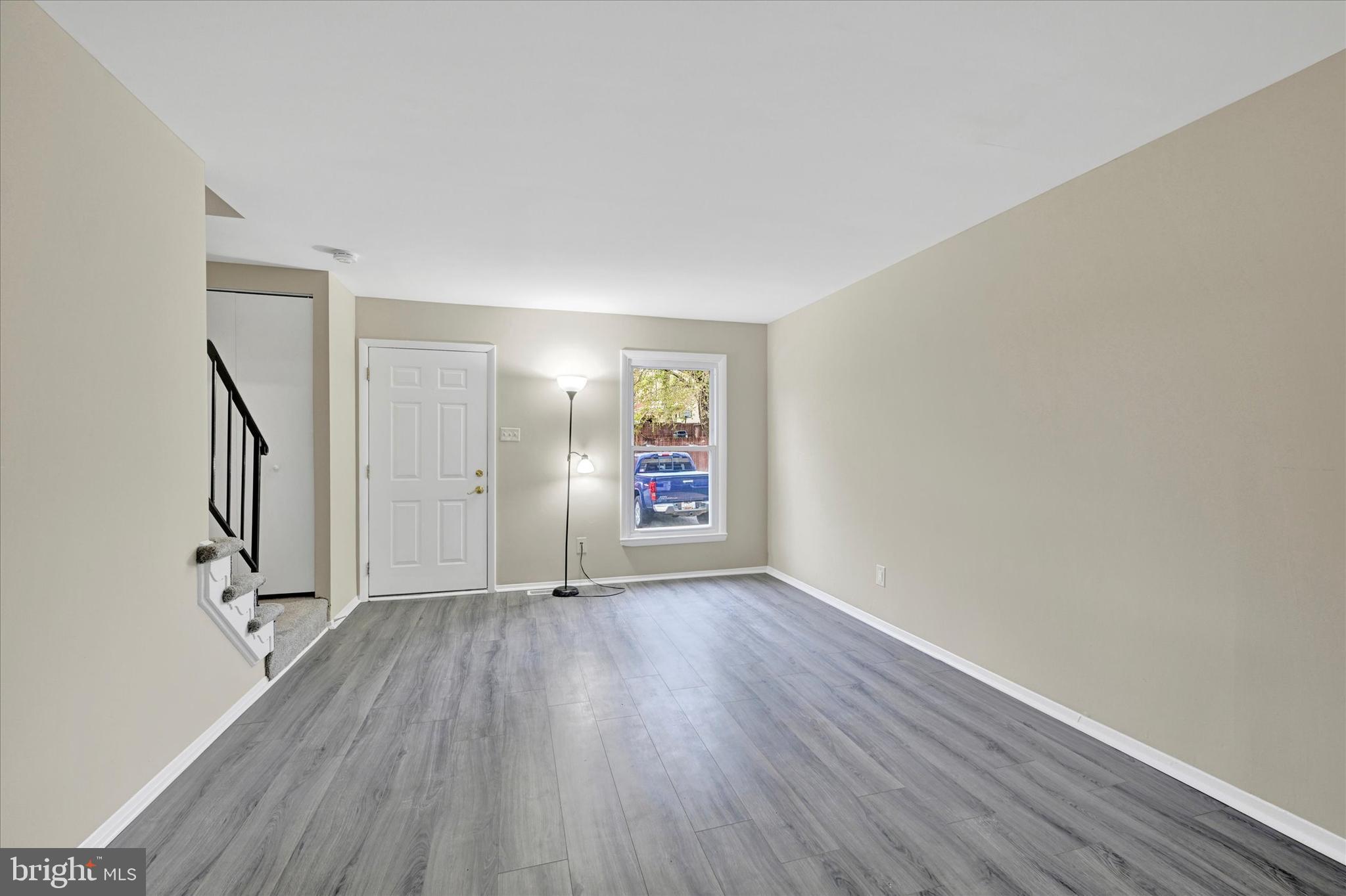 3447 Santee Road Baltimore, MD 21236 - Photo 3 of 32 wooden floor in an empty room with a window
