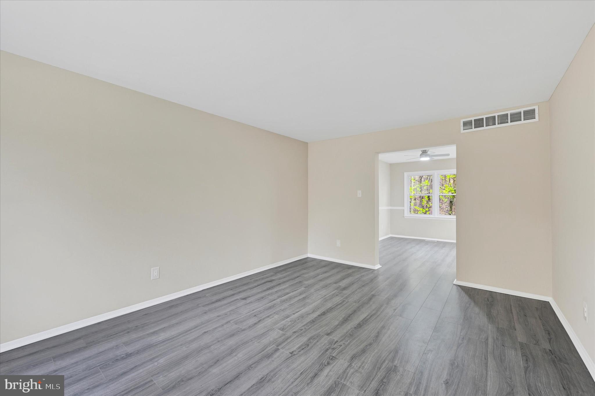 3447 Santee Road Baltimore, MD 21236 - Photo 5 of 32 an empty room with wooden floor and windows