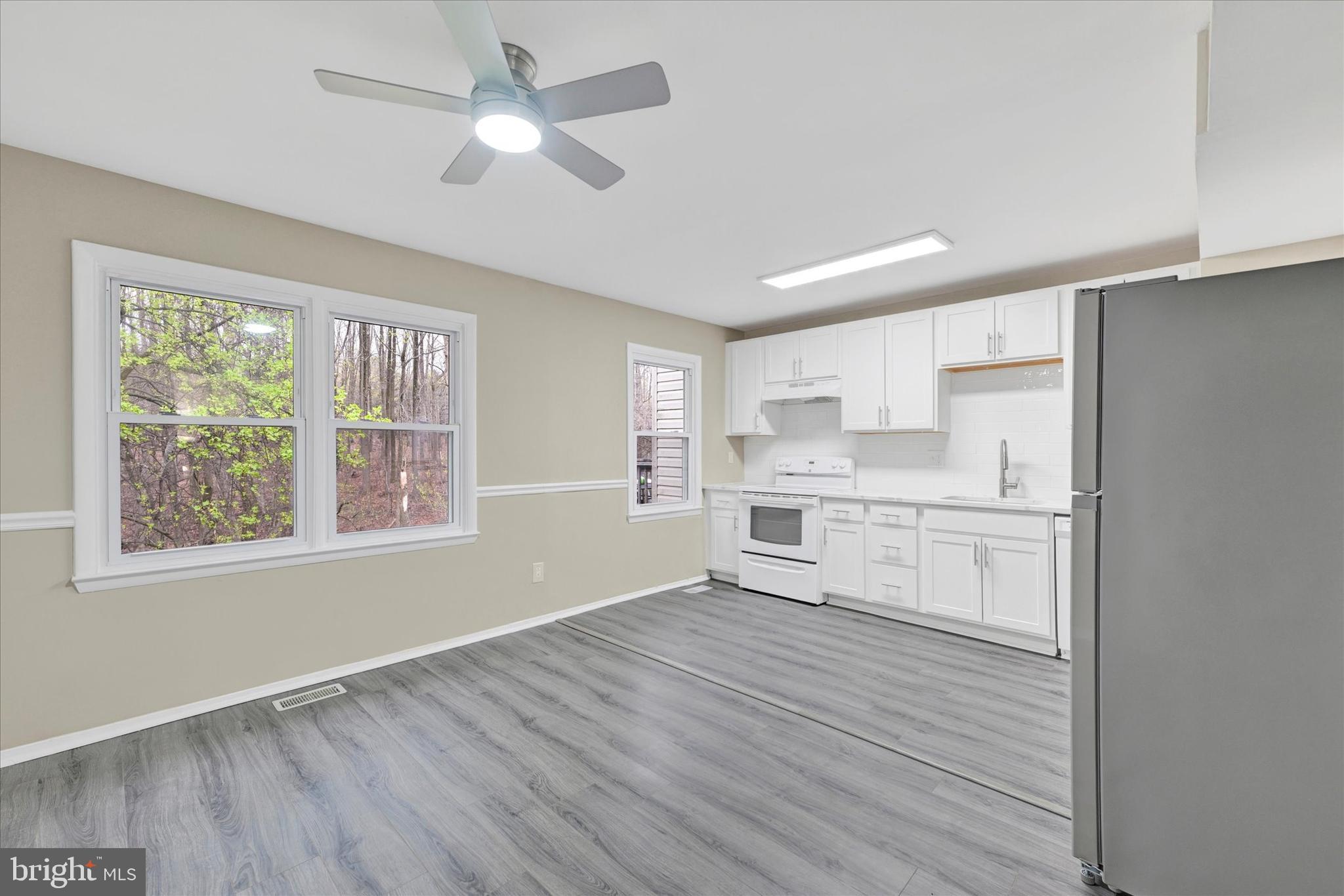 3447 Santee Road Baltimore, MD 21236 - Photo 8 of 32 a view of kitchen with wooden floor electronic appliances and window