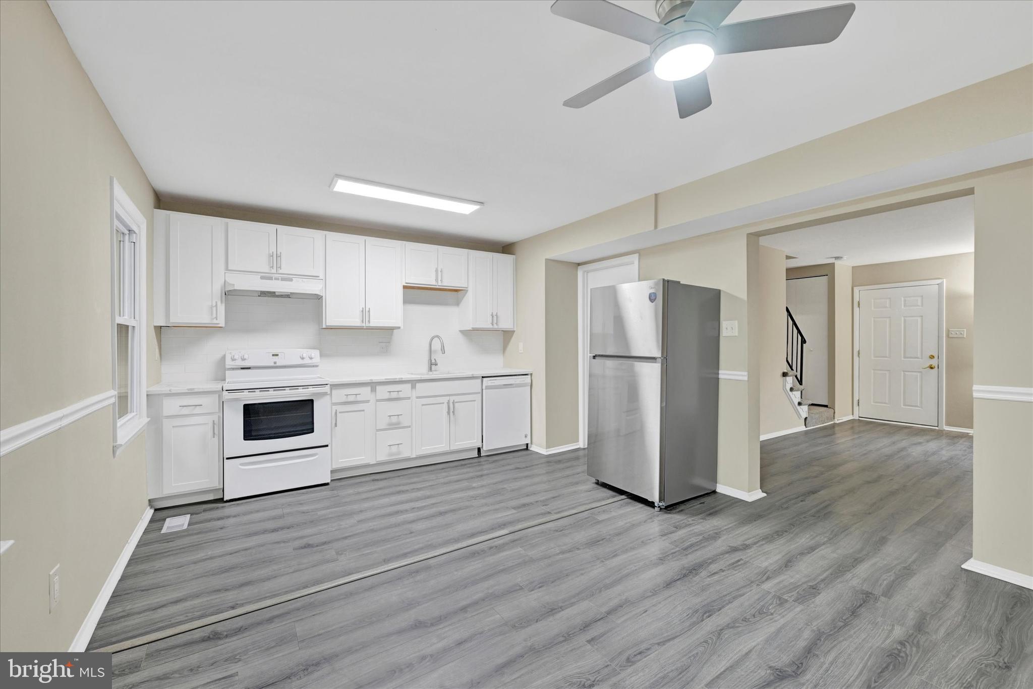 3447 Santee Road Baltimore, MD 21236 - Photo 9 of 32 a kitchen with stainless steel appliances a refrigerator sink and cabinets