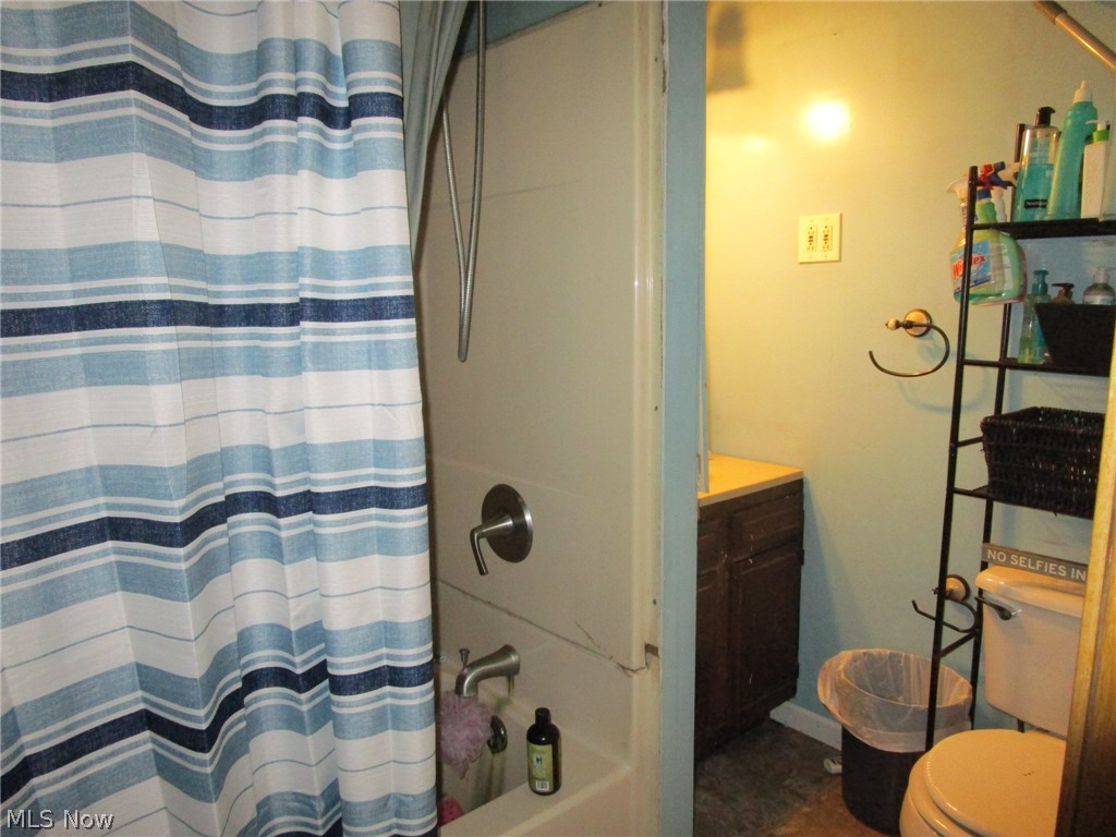 5560 Dodge Road Rome, OH 44085 - Photo 18 of 49 Full bathroom featuring vanity, shower / bath combo with shower curtain, and toilet