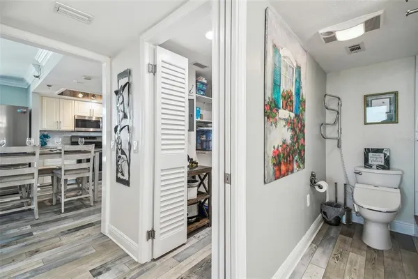 a bathroom with a granite countertop toilet a sink and a mirror