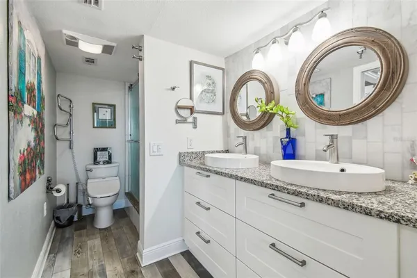a bathroom with a toilet sink and shower