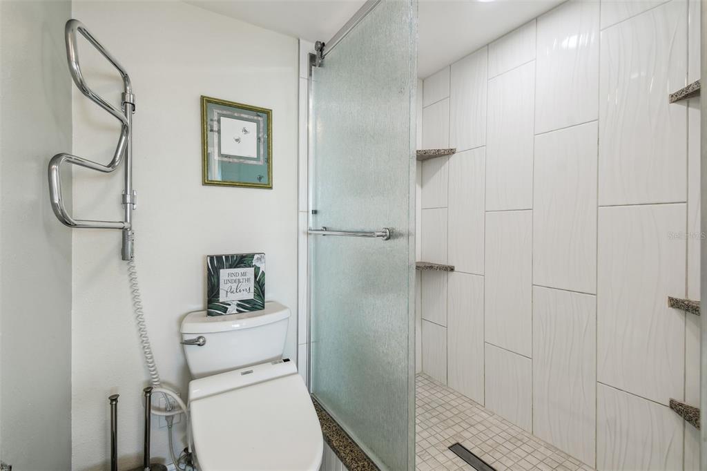5915 Sea Ranch Drive, Unit 703 Hudson, FL 34667 - Photo 15 of 54 a bathroom with a toilet sink and shower