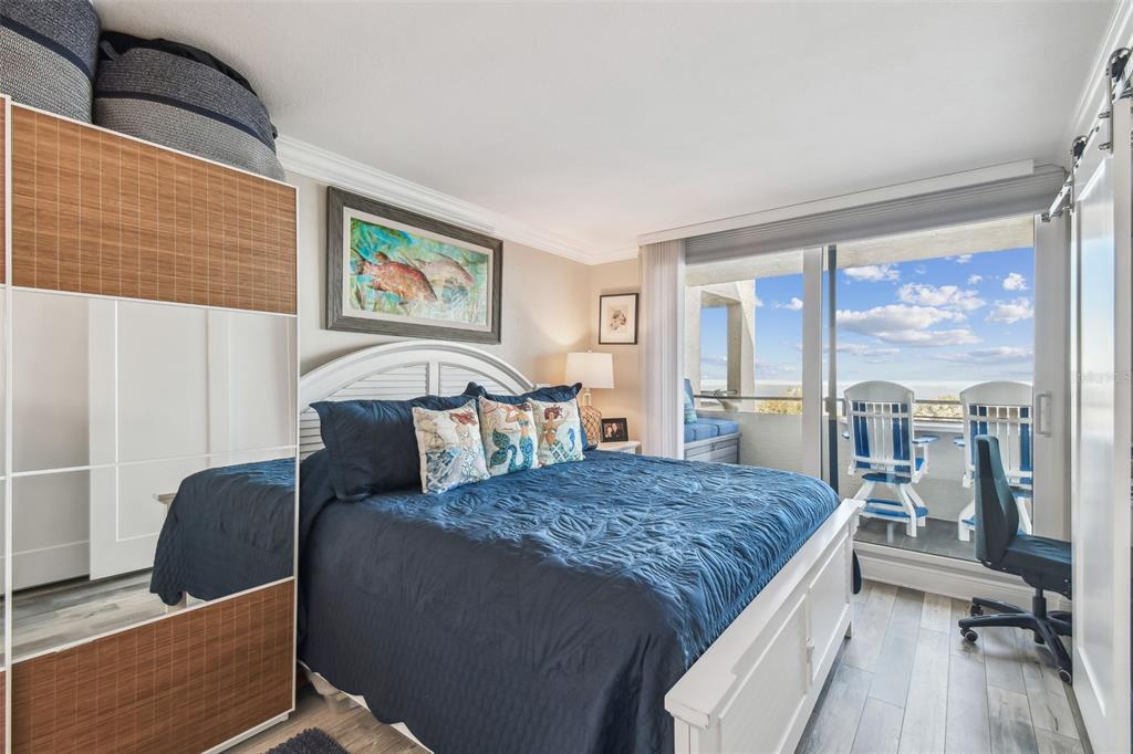 5915 Sea Ranch Drive, Unit 703 Hudson, FL 34667 - Photo 17 of 54 a bed sitting in a bedroom next to a window