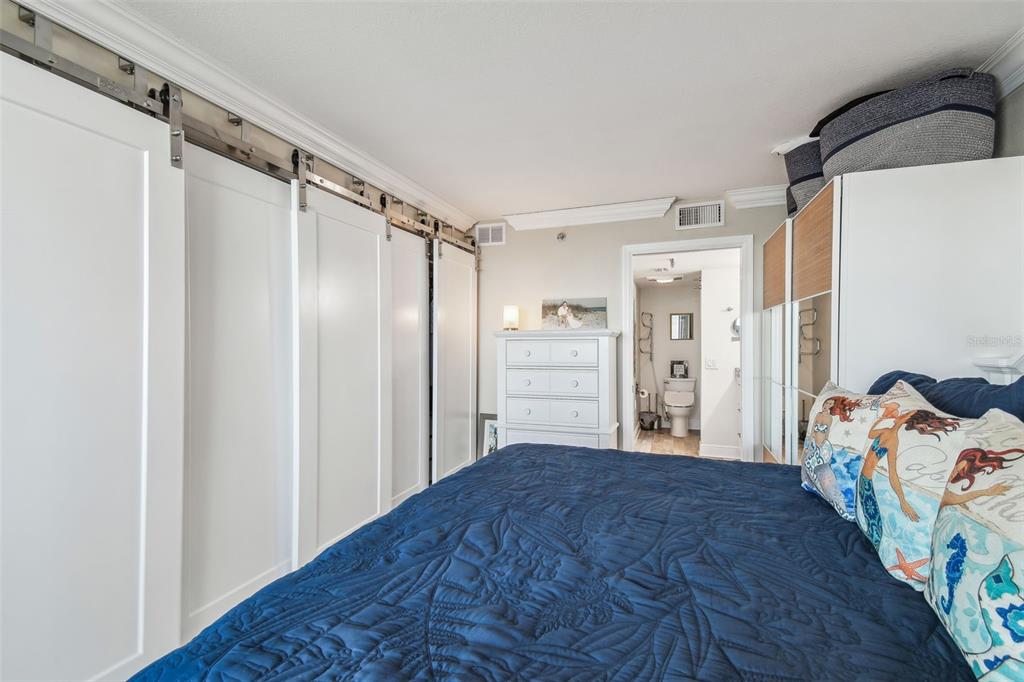 5915 Sea Ranch Drive, Unit 703 Hudson, FL 34667 - Photo 18 of 54 a bedroom with a bed and a walk in closet