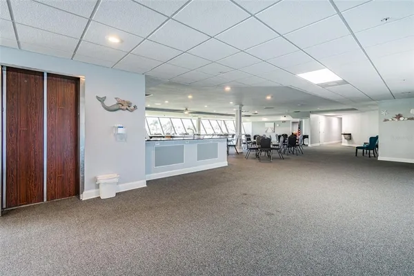 a dining room with furniture and floor to ceiling window