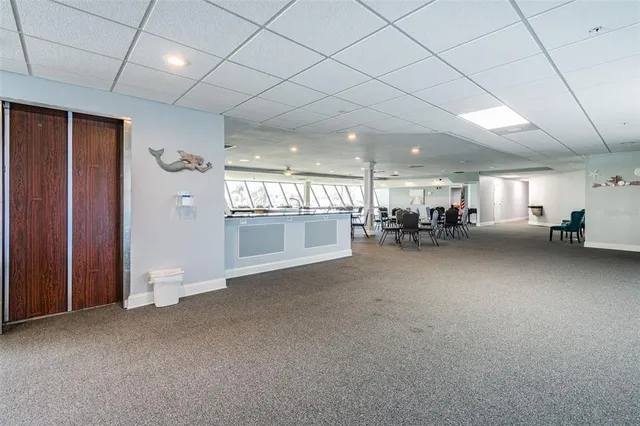a dining room with furniture and floor to ceiling window