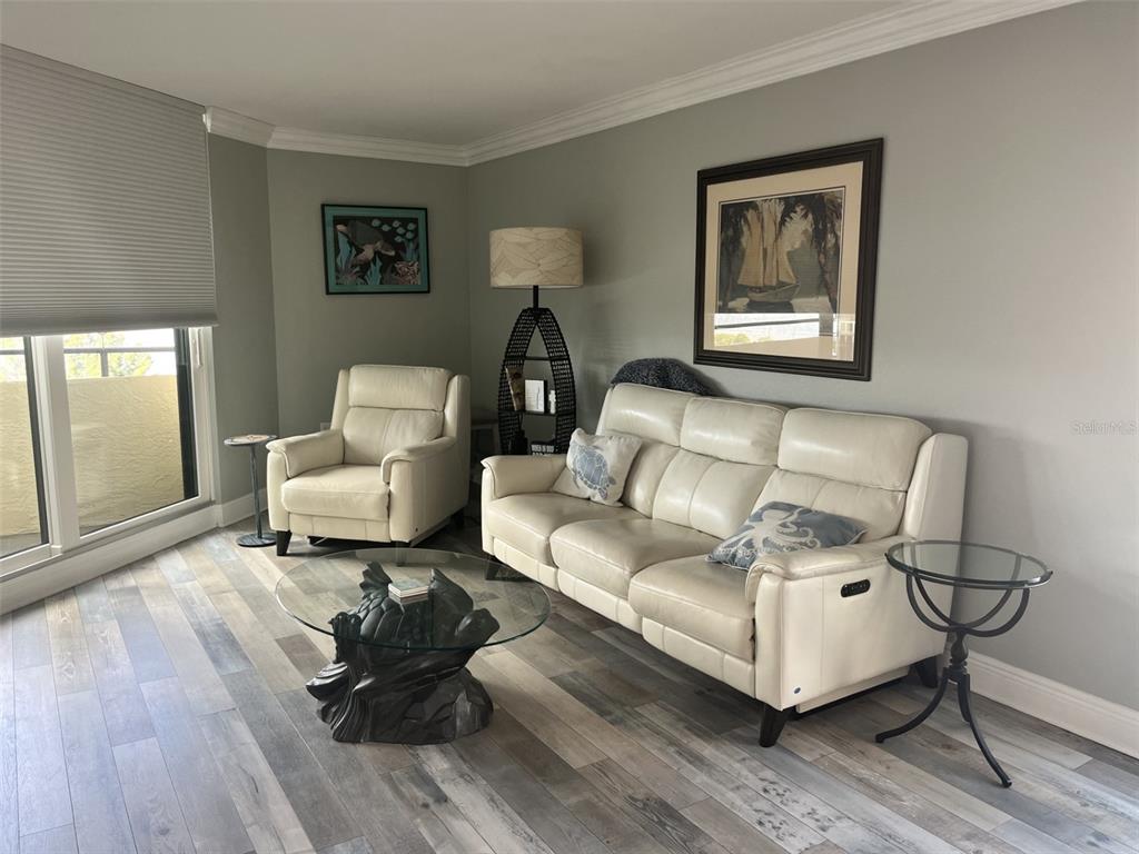5915 Sea Ranch Drive, Unit 703 Hudson, FL 34667 - Photo 4 of 54 a living room with furniture and a wooden floor