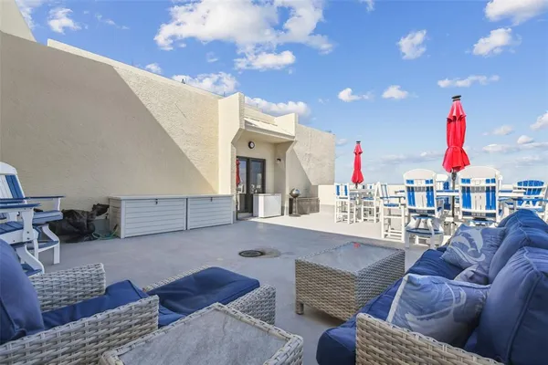 a view of a dining room with furniture and kitchen view