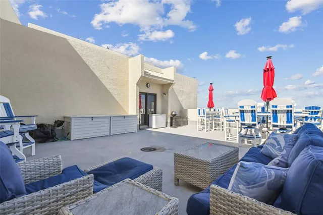 a view of a dining room with furniture and kitchen view