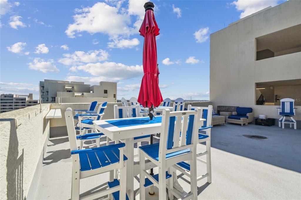 5915 Sea Ranch Drive, Unit 703 Hudson, FL 34667 - Photo 52 of 54 a view of a patio with a table and chairs and potted plants
