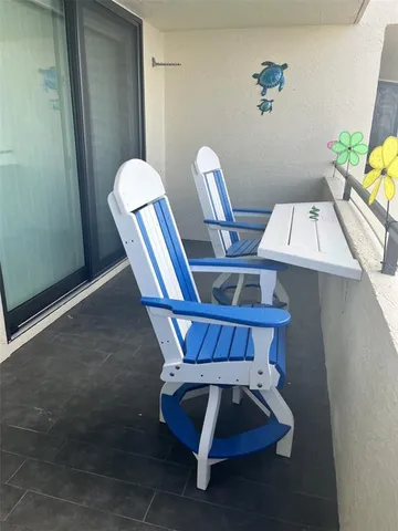 a view of table and chairs in the room