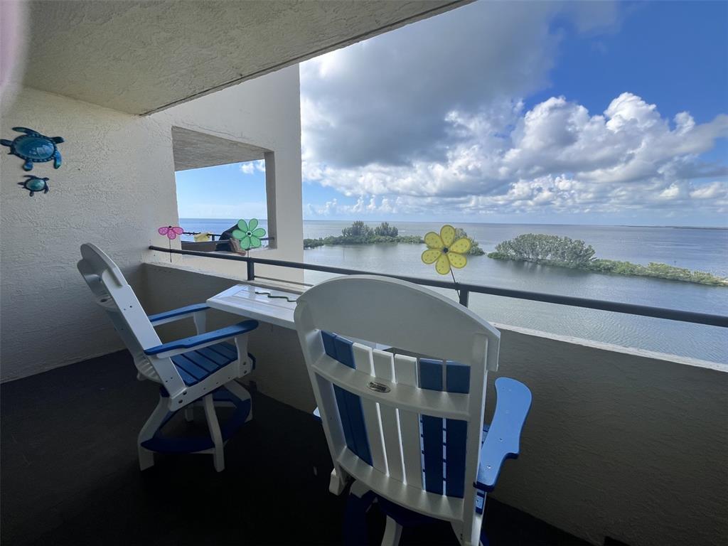 5915 Sea Ranch Drive, Unit 703 Hudson, FL 34667 - Photo 7 of 54 a dining room with furniture and a floor to ceiling window