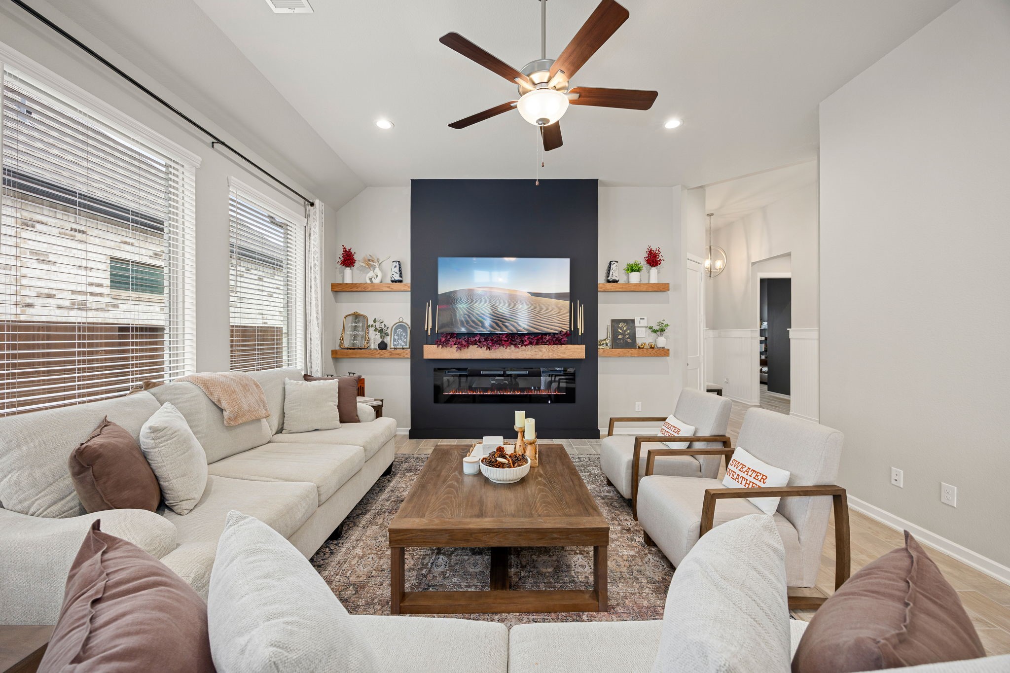 a living room with furniture a large window and a flat screen tv