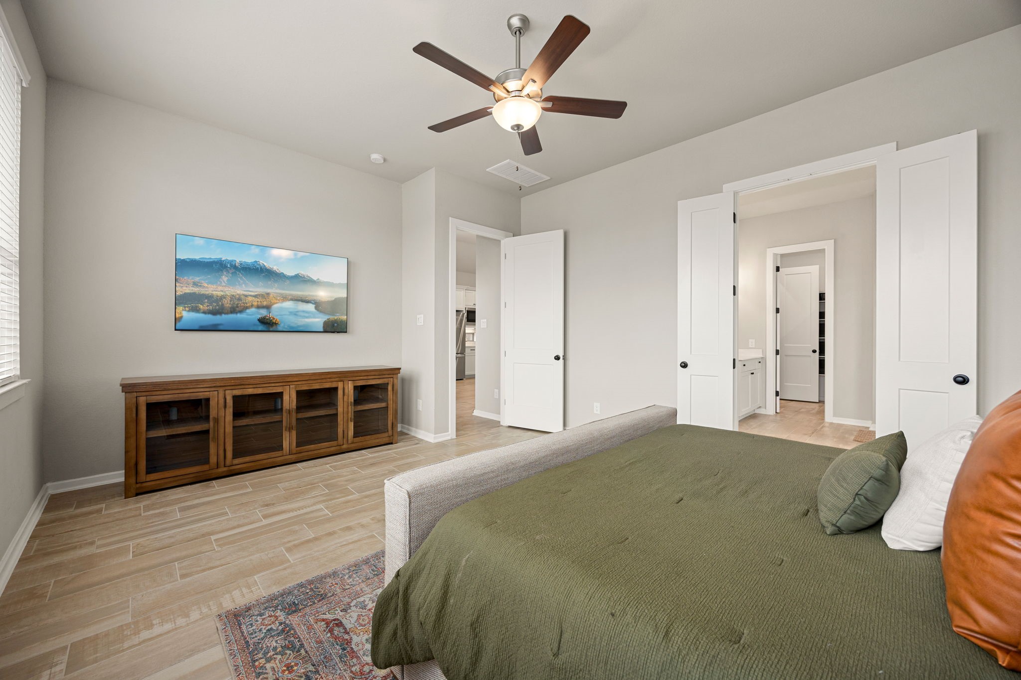 4823 Vaughan Way Iowa Colony, TX 77583 - Photo 13 of 29 a bedroom with a large bed and a chandelier