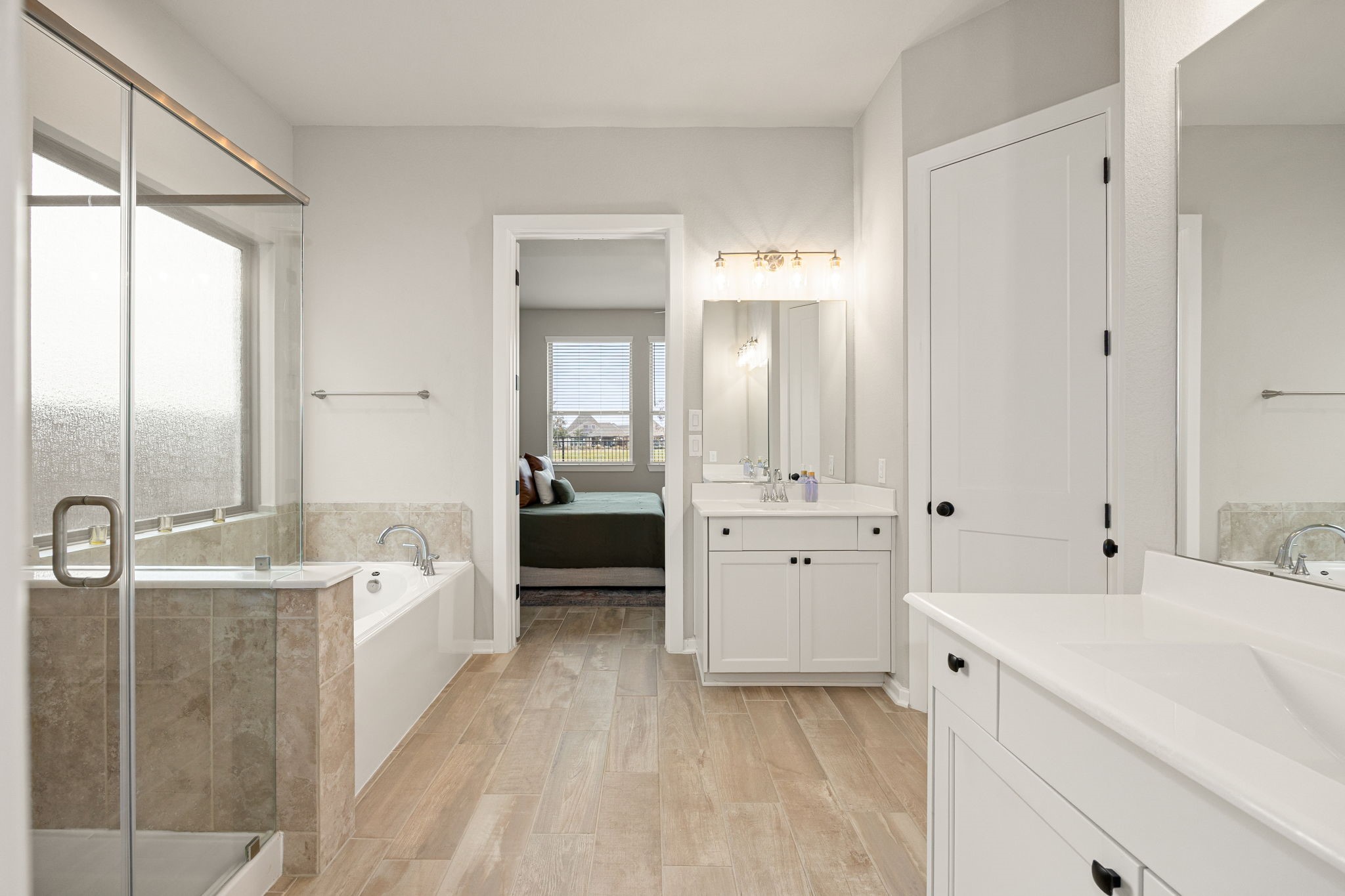 4823 Vaughan Way Iowa Colony, TX 77583 - Photo 14 of 29 a spacious bathroom with a tub sink and mirror