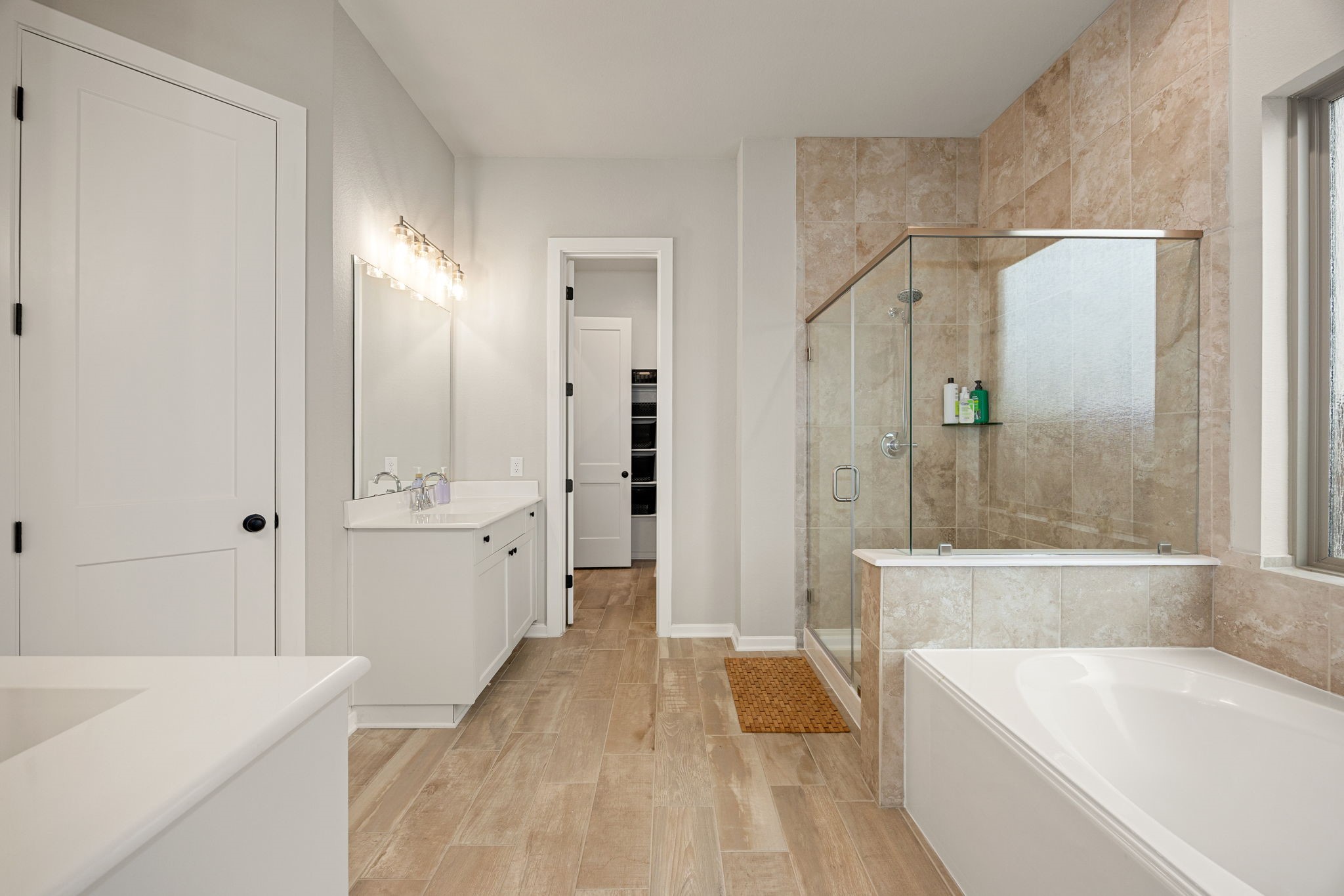 4823 Vaughan Way Iowa Colony, TX 77583 - Photo 15 of 29 a bathroom with a tub a sink and a large mirror