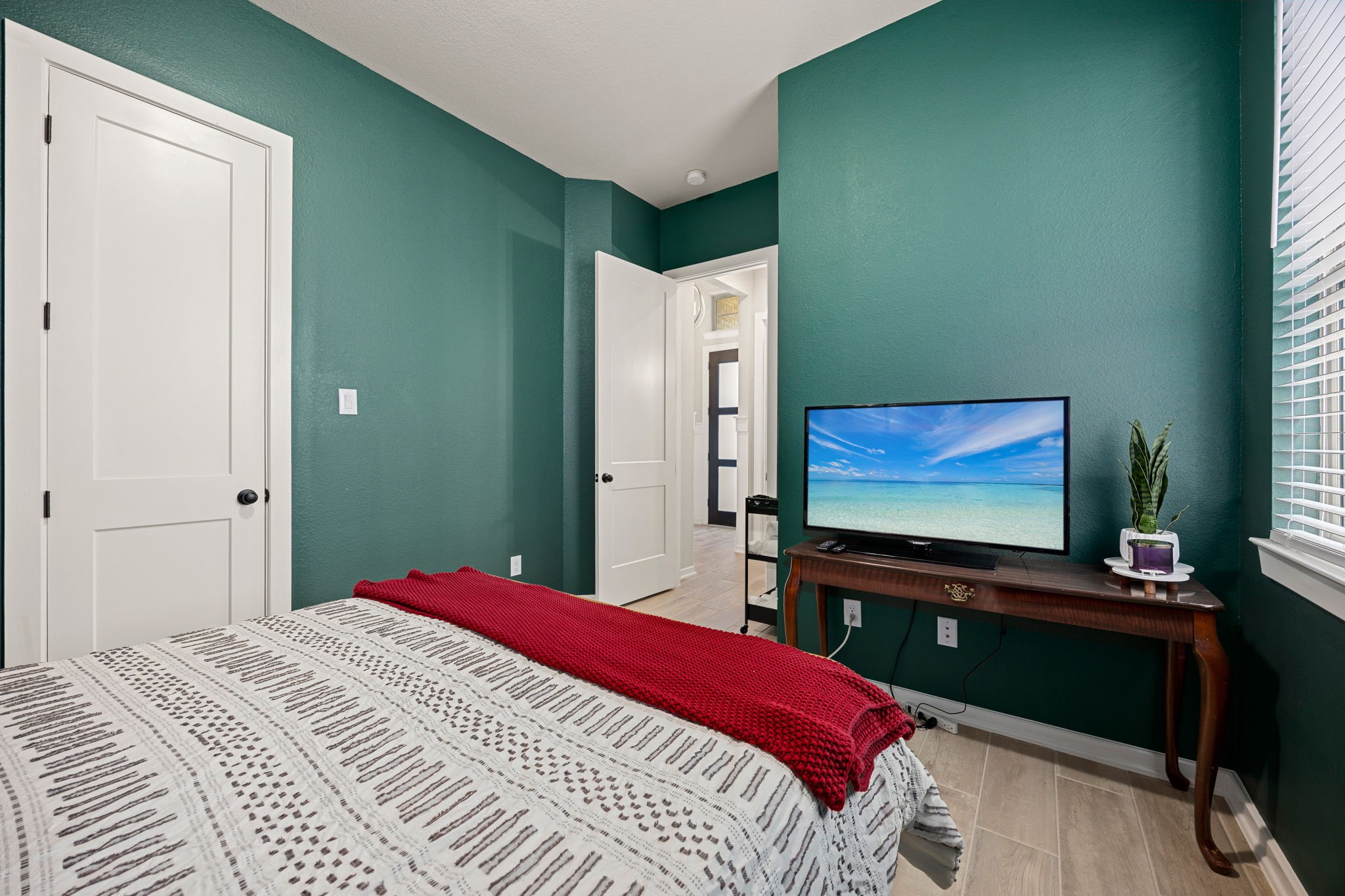 4823 Vaughan Way Iowa Colony, TX 77583 - Photo 19 of 29 a bedroom with a bed and a flat screen tv