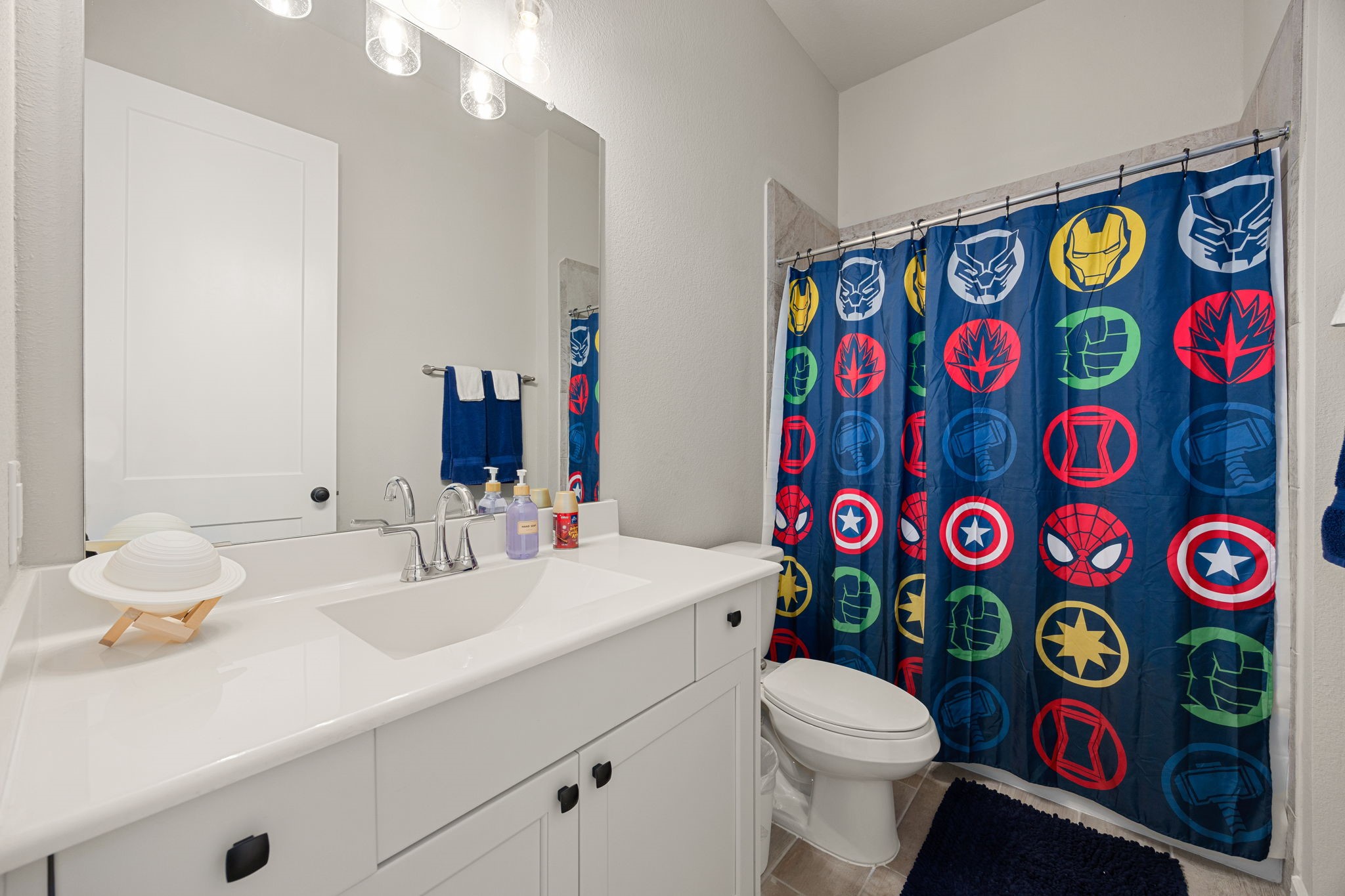 4823 Vaughan Way Iowa Colony, TX 77583 - Photo 22 of 29 a bathroom with a sink and a blue curtain