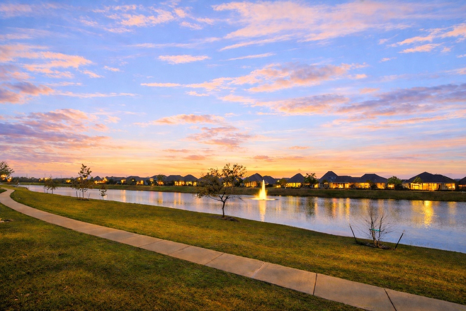 4823 Vaughan Way Iowa Colony, TX 77583 - Photo 4 of 29 a view of a lake with houses in the background