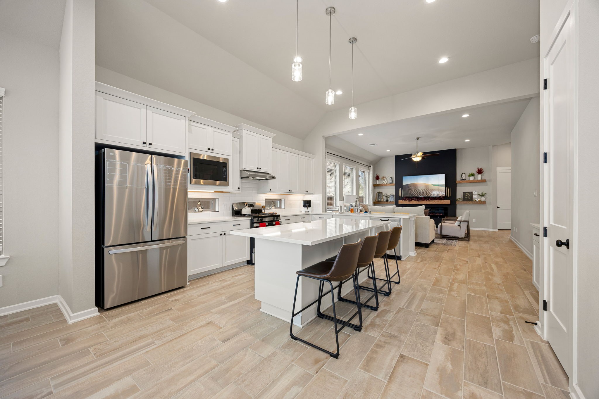 4823 Vaughan Way Iowa Colony, TX 77583 - Photo 7 of 29 a kitchen with stainless steel appliances a refrigerator stove microwave and cabinets