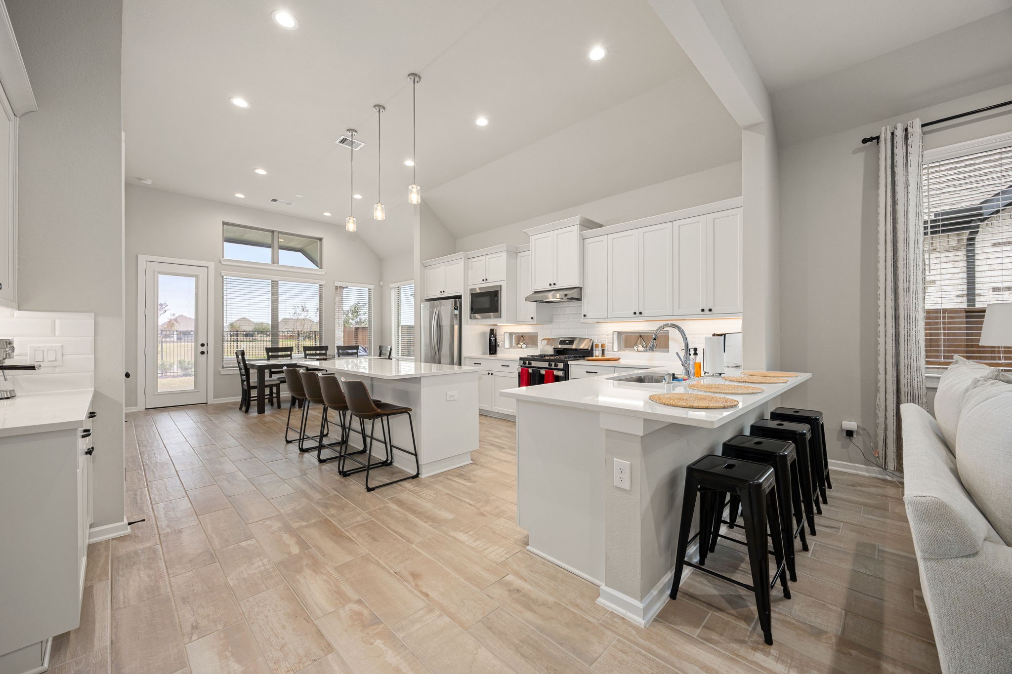 4823 Vaughan Way Iowa Colony, TX 77583 - Photo 8 of 29 a kitchen with stainless steel appliances kitchen island granite countertop a sink and cabinets