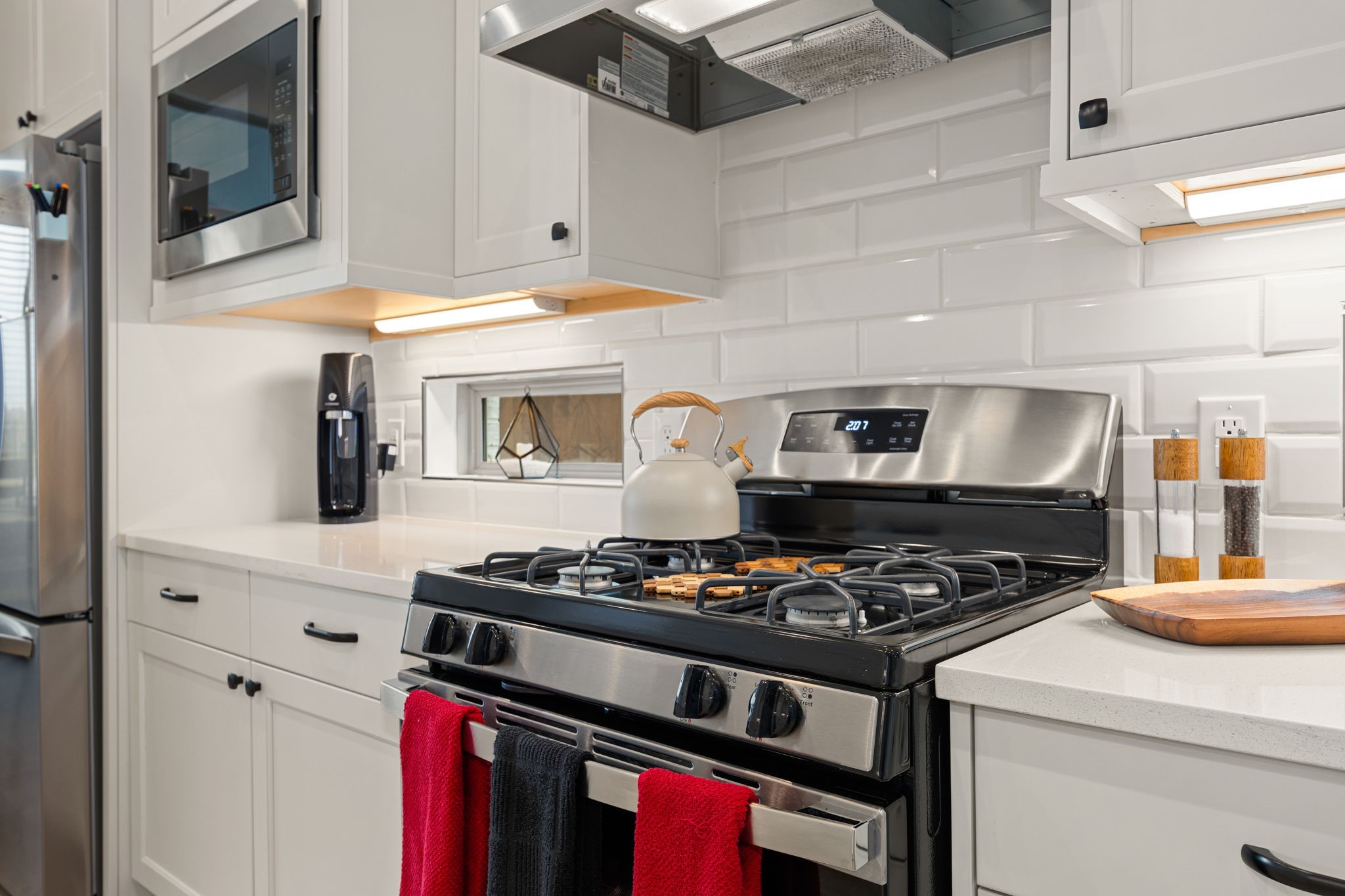 4823 Vaughan Way Iowa Colony, TX 77583 - Photo 9 of 29 a kitchen with stainless steel appliances granite countertop a stove and a microwave