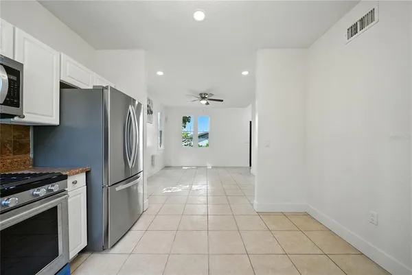 a kitchen with stainless steel appliances a refrigerator and a stove top oven