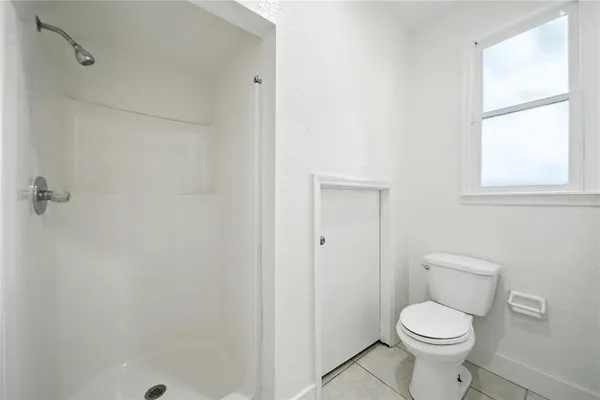 a white toilet sitting next to a bathroom sink