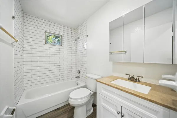 a bathroom with a sink a toilet and bathtub