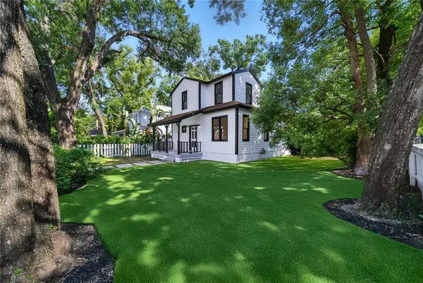 a view of house with a yard