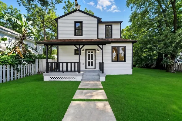 a front view of a house with a garden and deck