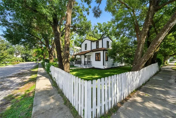 a view of a house with wooden fence