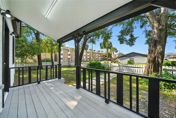a view of a balcony with wooden floor
