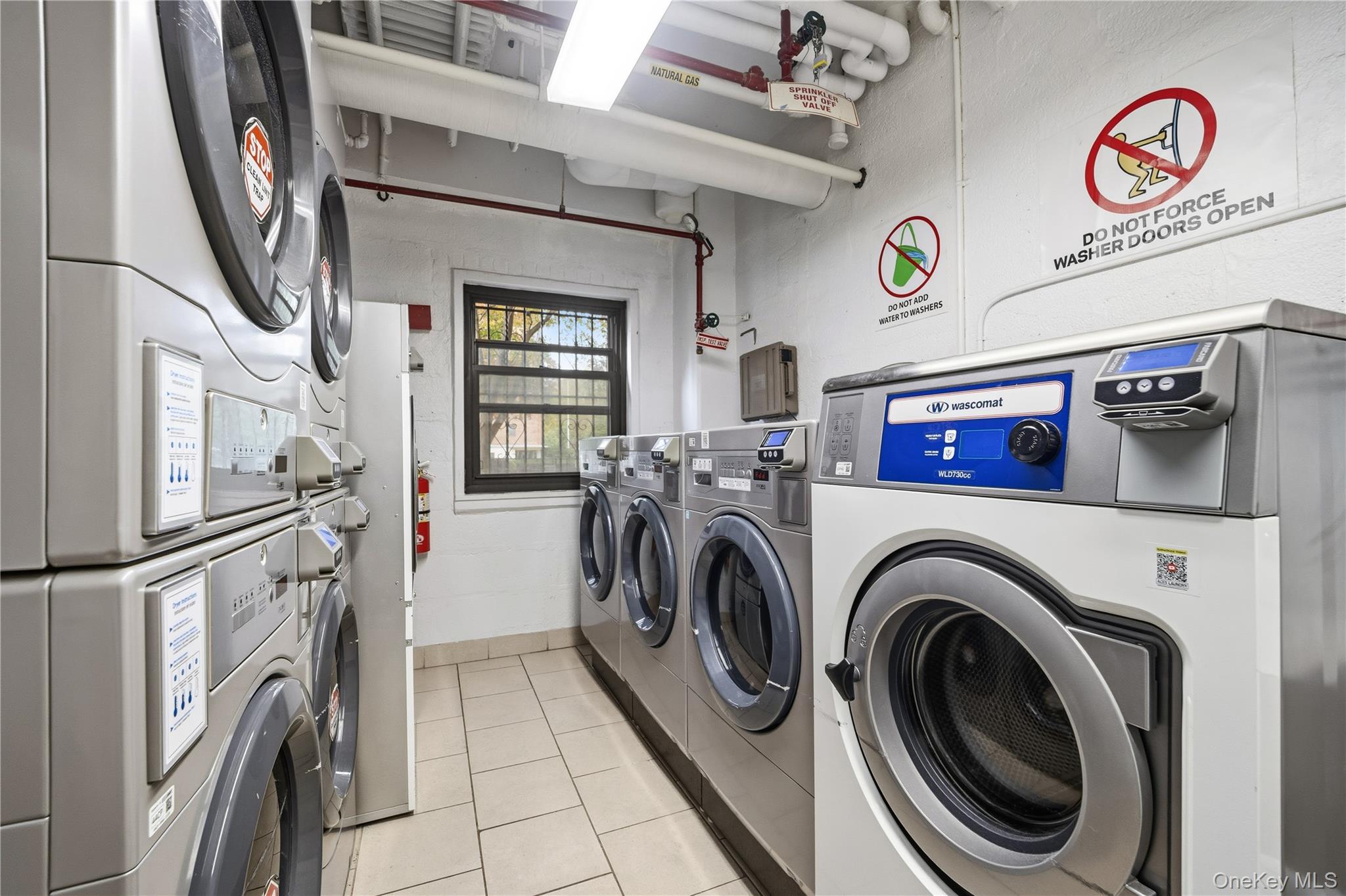21-41 34th Avenue, Unit 7B Queens, NY 11106 - Photo 12 of 14 Communal laundry room featuring estacked washer and dryer and washer and clothes dryer