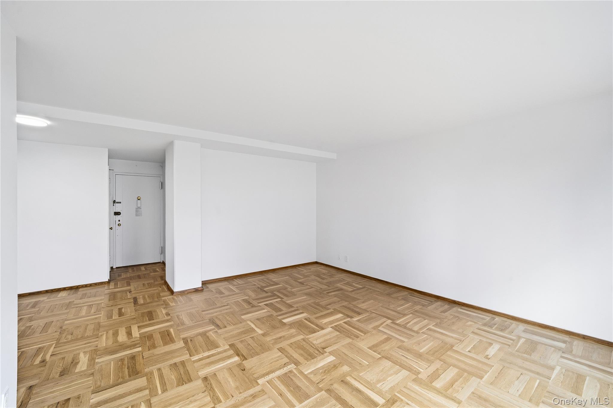 21-41 34th Avenue, Unit 7B Queens, NY 11106 - Photo 3 of 14 Unfurnished room with baseboards