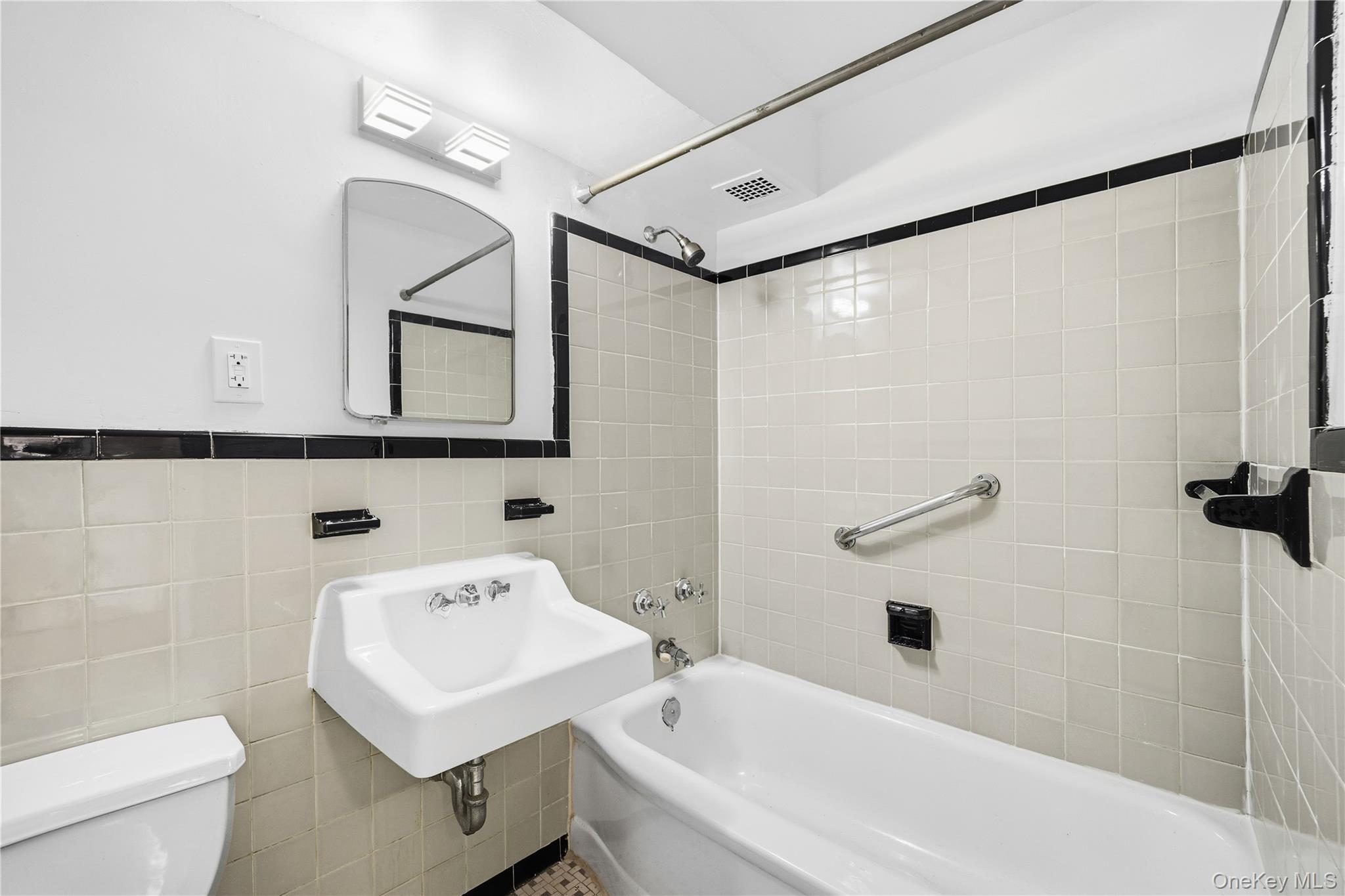 21-41 34th Avenue, Unit 7B Queens, NY 11106 - Photo 6 of 14 Full bath with shower / washtub combination and tile walls