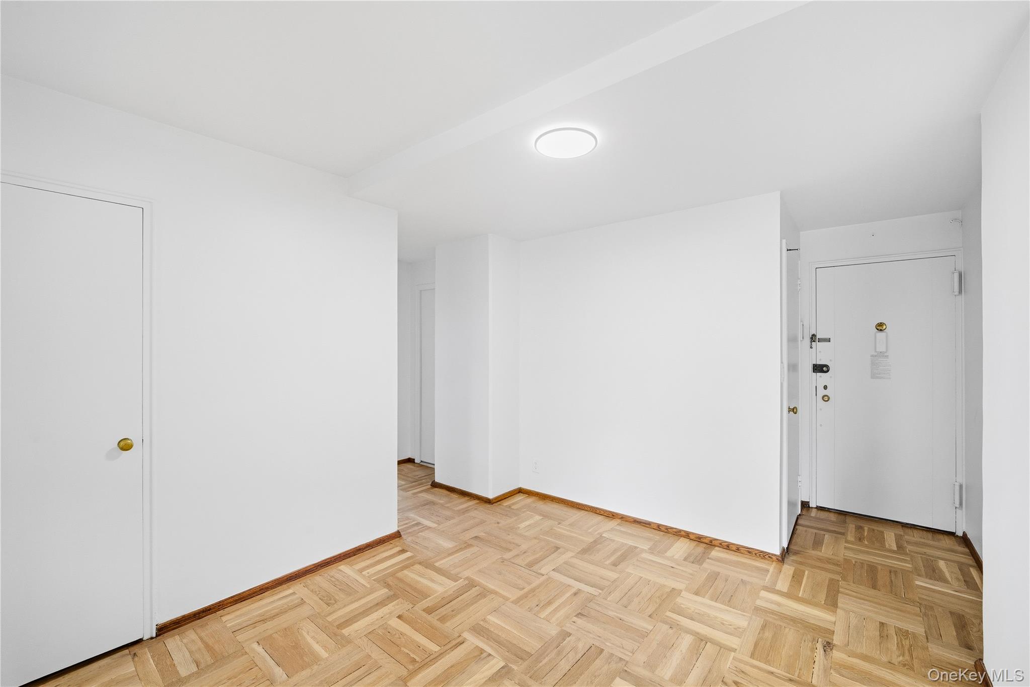 21-41 34th Avenue, Unit 7B Queens, NY 11106 - Photo 7 of 14 Spare room featuring baseboards