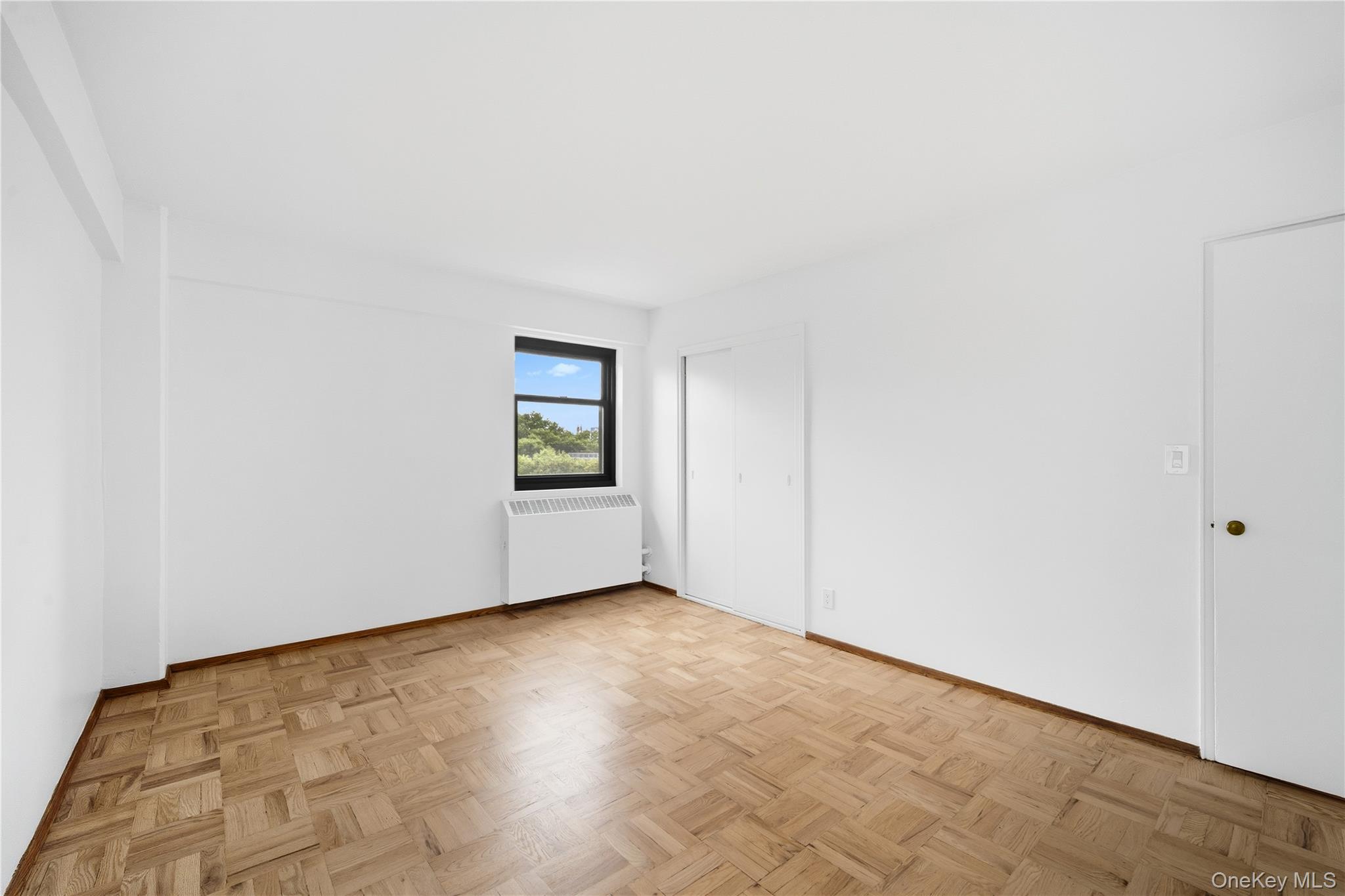 21-41 34th Avenue, Unit 7B Queens, NY 11106 - Photo 10 of 14 Spare room with radiator and baseboards