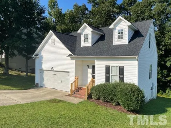 a view of a yard in front view of a house