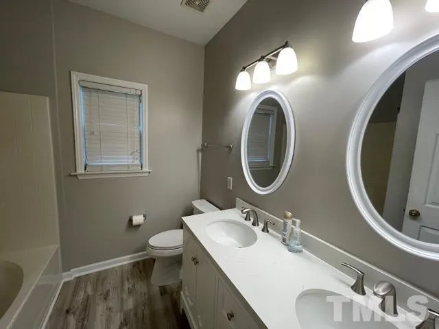 a bathroom with bathtub and shower
