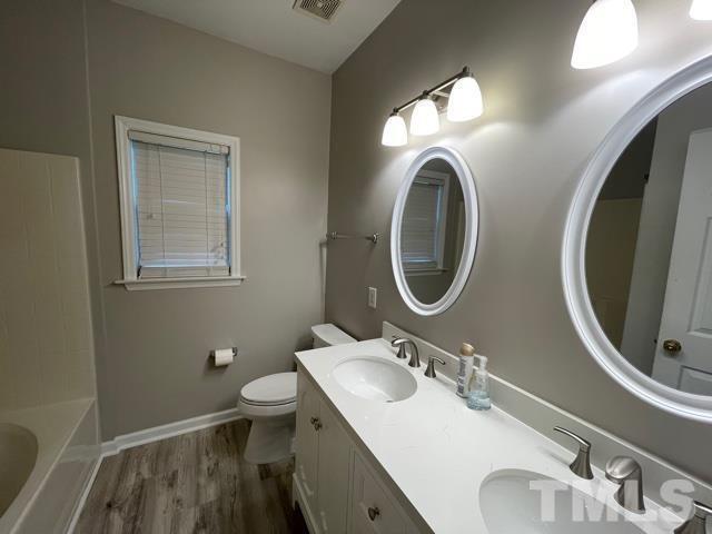 1007 Willowedge Court Knightdale, NC 27545 - Photo 14 of 21 a bathroom with a toilet a sink and a mirror