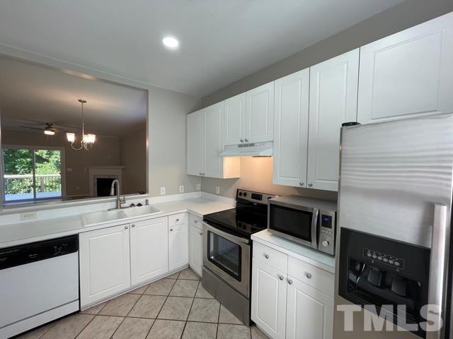 1007 Willowedge Court Knightdale, NC 27545 - Photo 5 of 21 a kitchen with a sink stove and cabinets