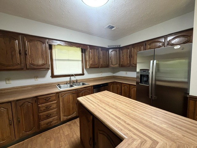 7643 Harper Road Joelton, TN 37080 - Photo 6 of 11 a kitchen with stainless steel appliances wooden cabinets a sink and a stove