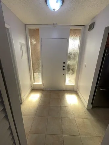 a view of an empty room and a bathroom