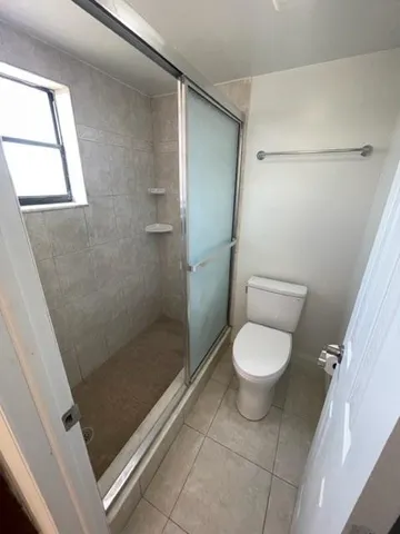 a bathroom with a toilet and a shower