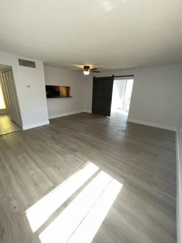 a view of a living room with kitchen countertops and a window