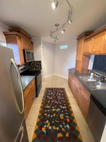 a kitchen with granite countertop a stove and a refrigerator
